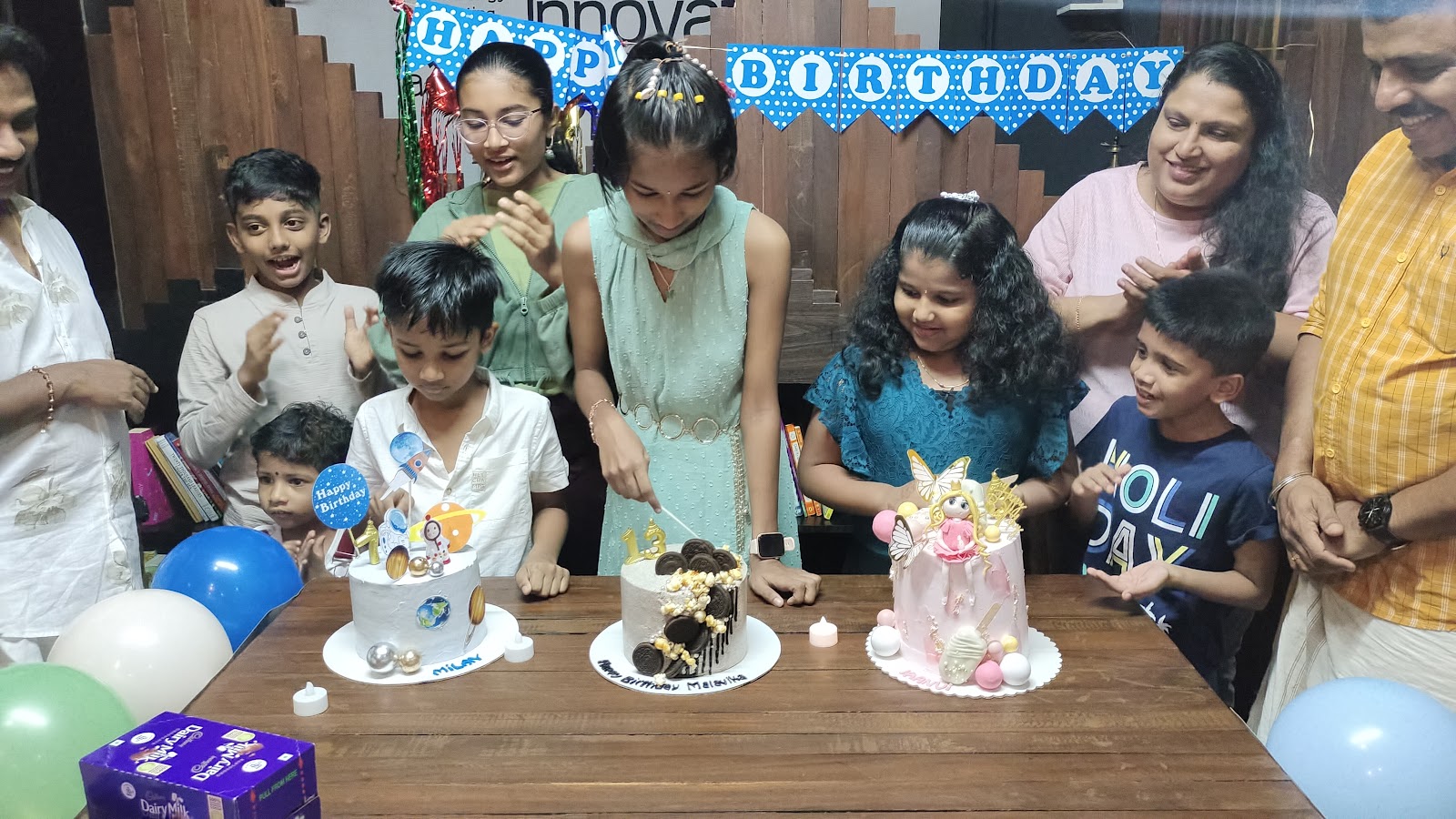 Three birthday cakes shared at one Forwords table