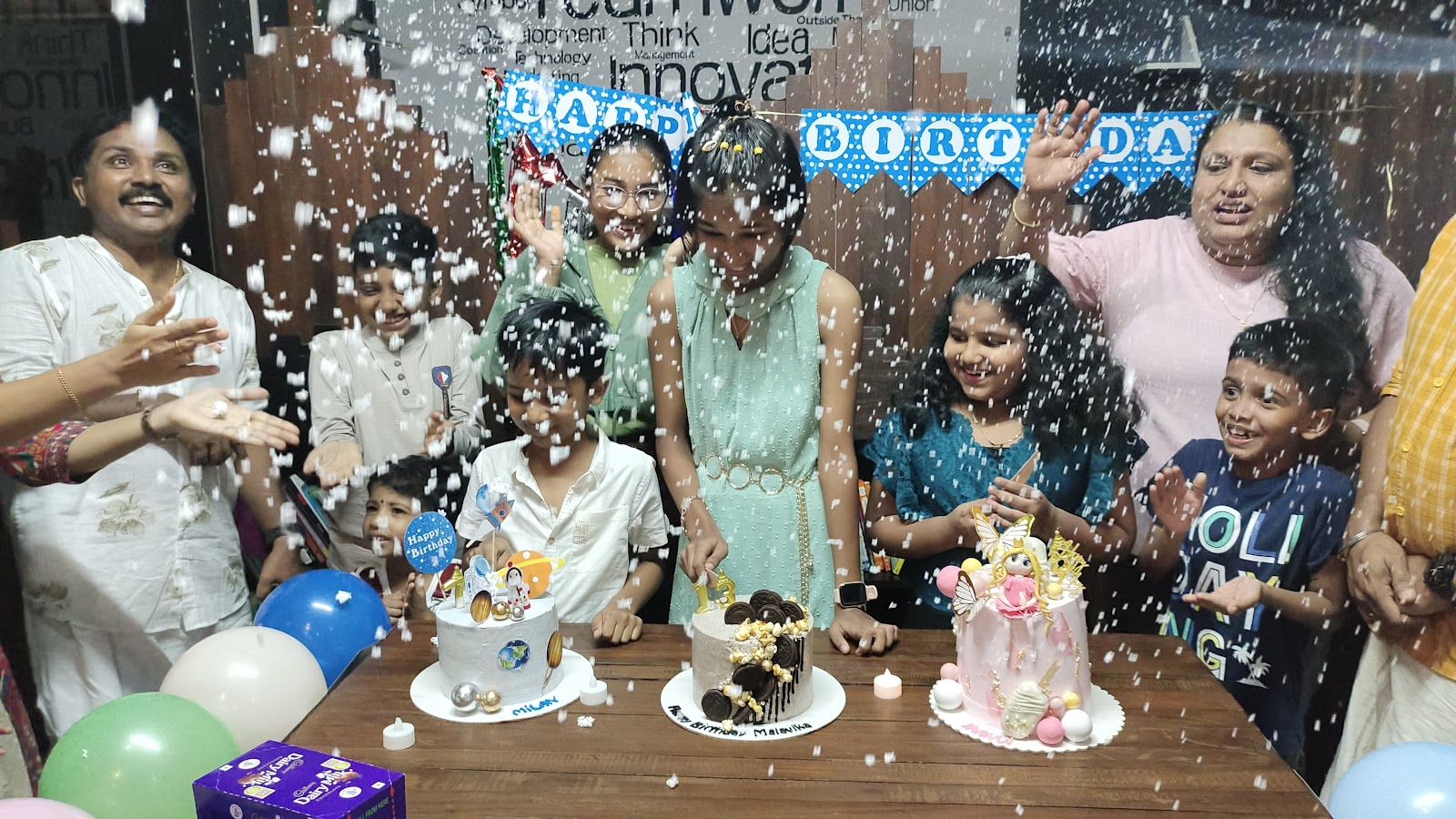 Friends and family celebrating birthdays with cakes and confetti at Forwords