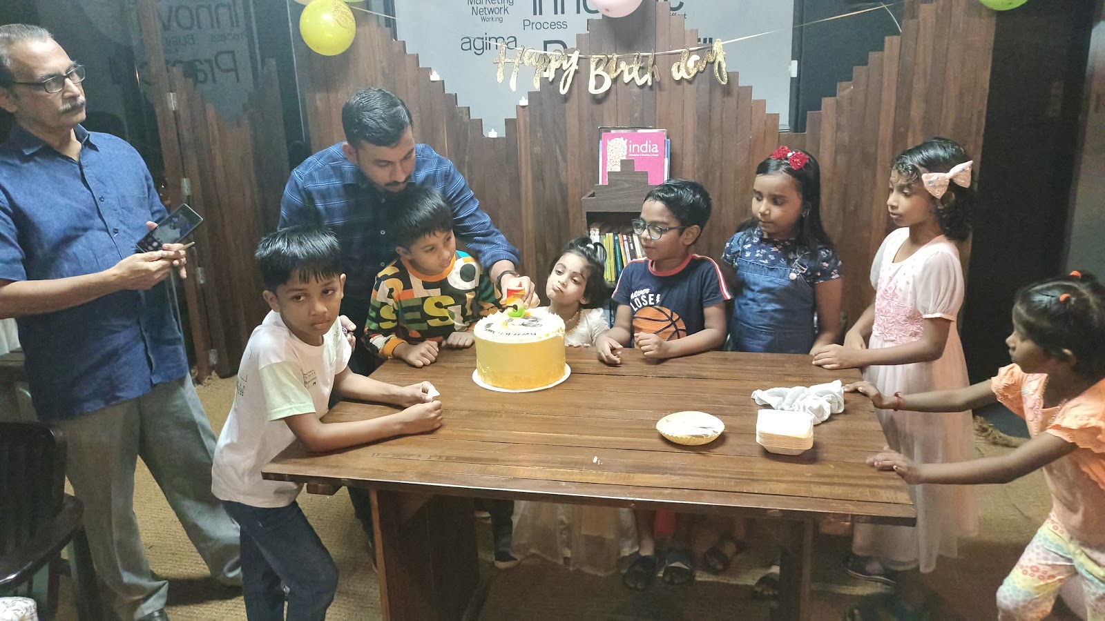 Lighting a candle on a yellow birthday cake