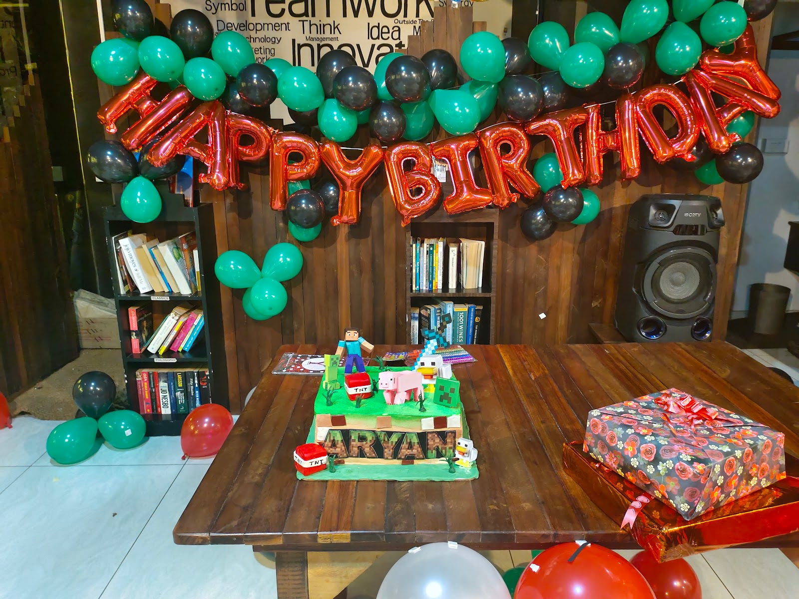 A themed birthday setup with balloons and bookshelves