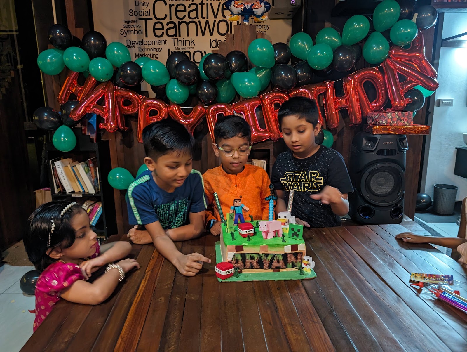 Children gathered around a Minecraft birthday cake