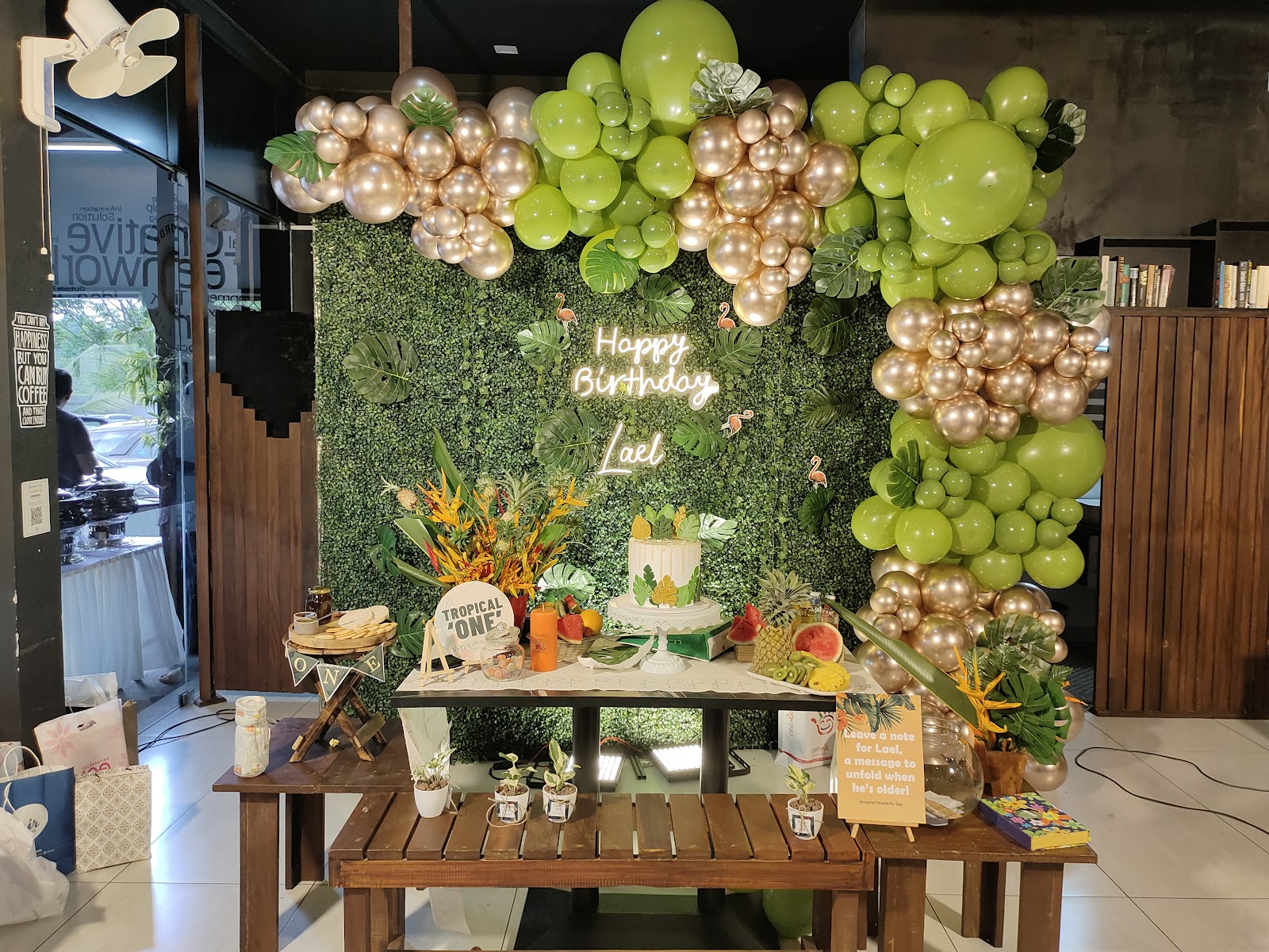 A tropical birthday table and backdrop set up at Forwords